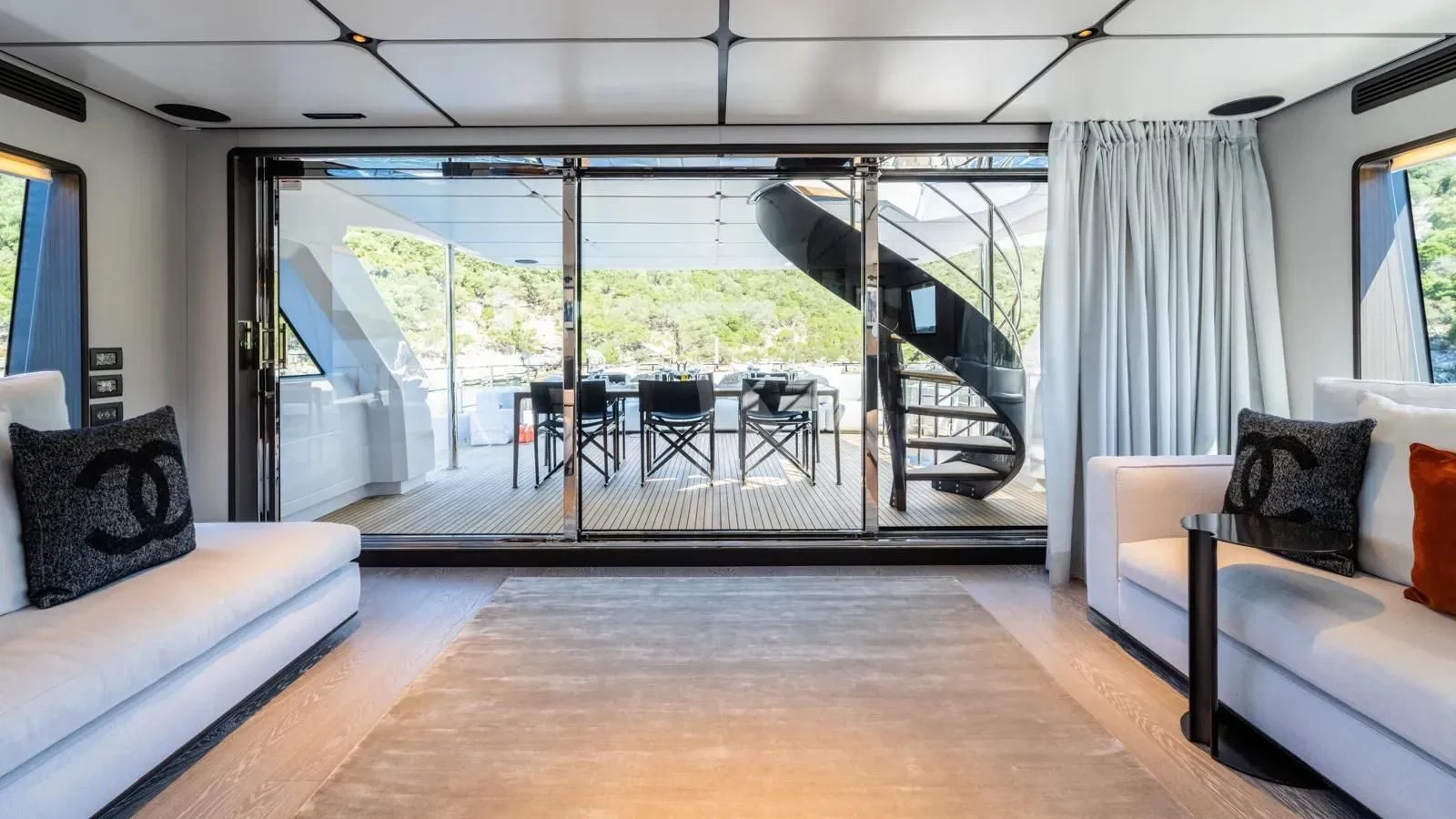 a living room with a glass door aboard AT ONE Yacht for Charter