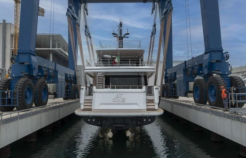 a large white boat in a harbor aboard AT ONE Yacht for Charter