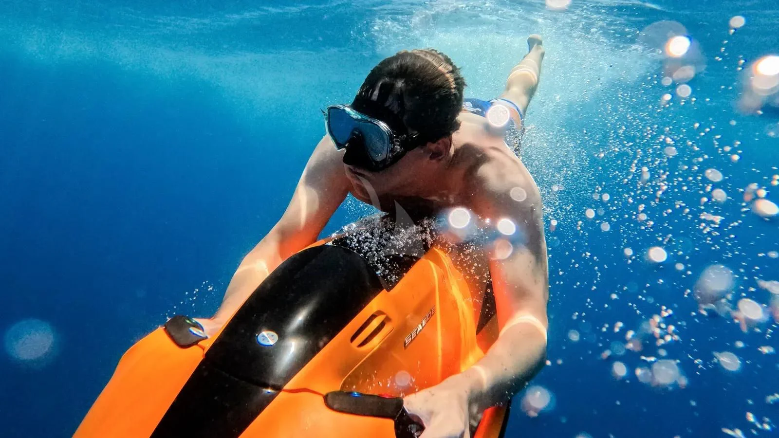 a man in a life jacket and goggles in a kayak aboard AT ONE Yacht for Charter