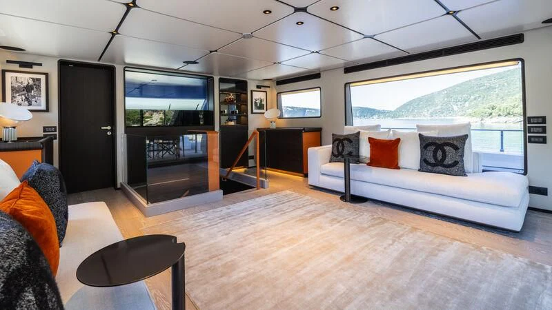a large living room with a large screen aboard AT ONE Yacht for Charter