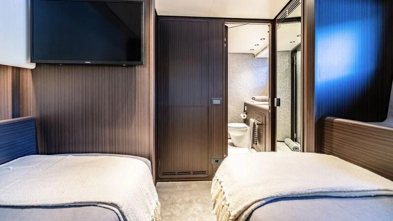 a room with a bed and a closet aboard AT ONE Yacht for Charter