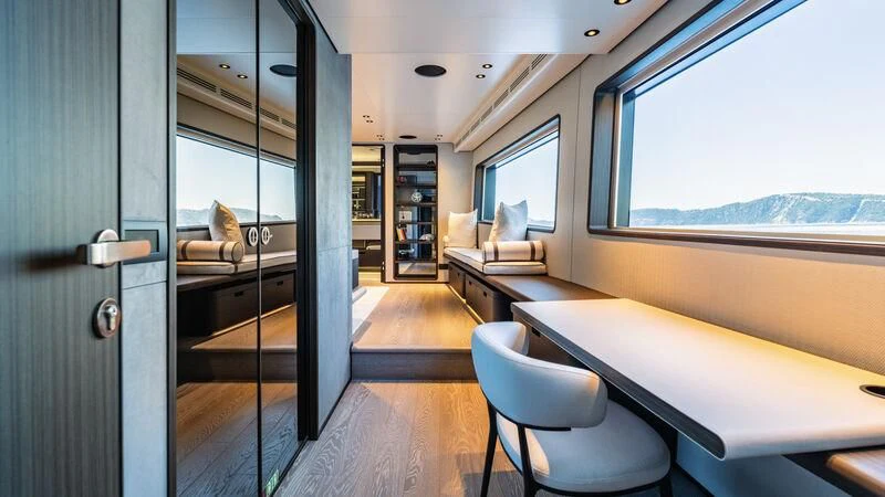 a room with a bed and a desk aboard AT ONE Yacht for Charter
