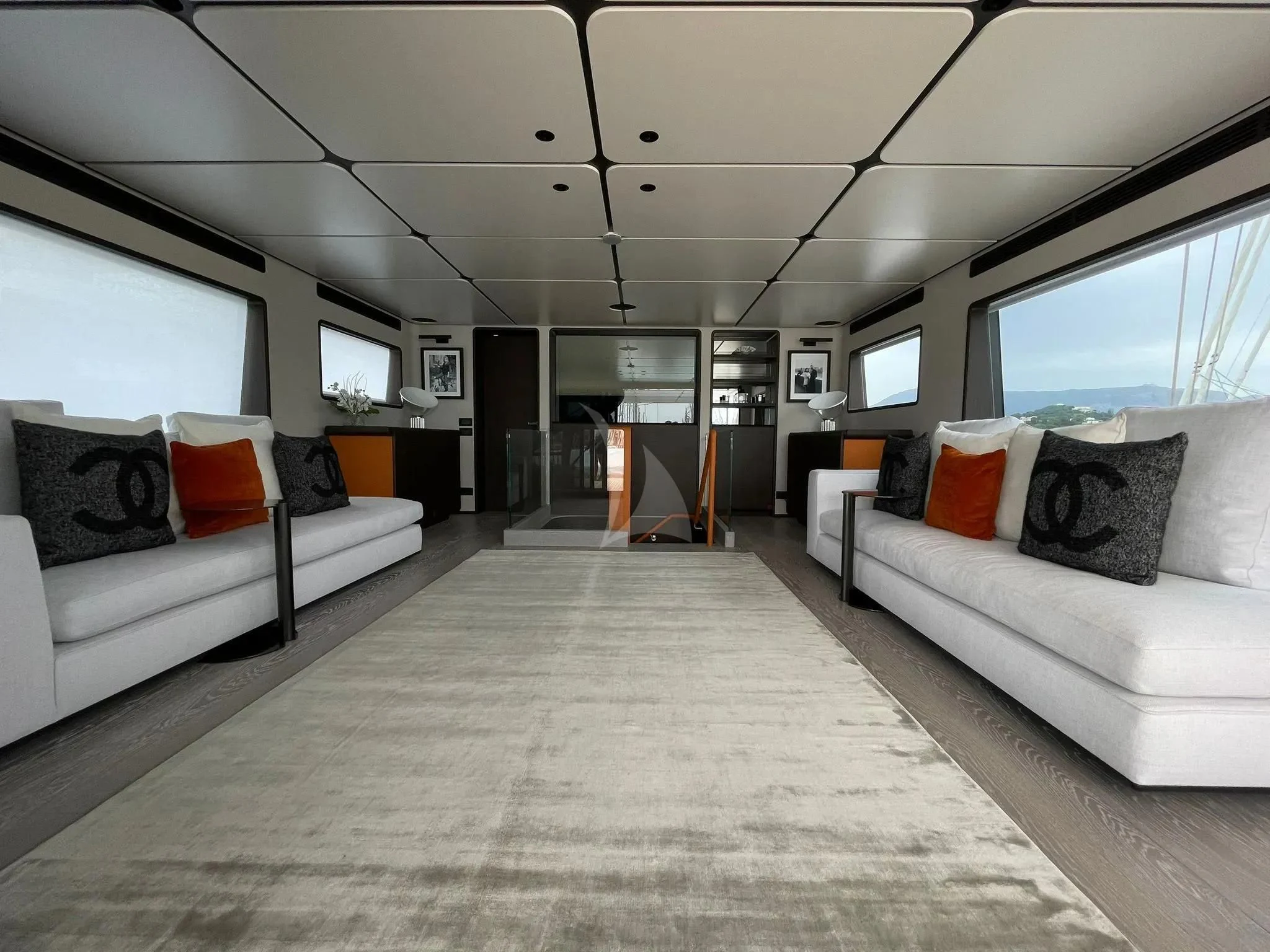 a room with a couch and a television aboard AT ONE Yacht for Charter