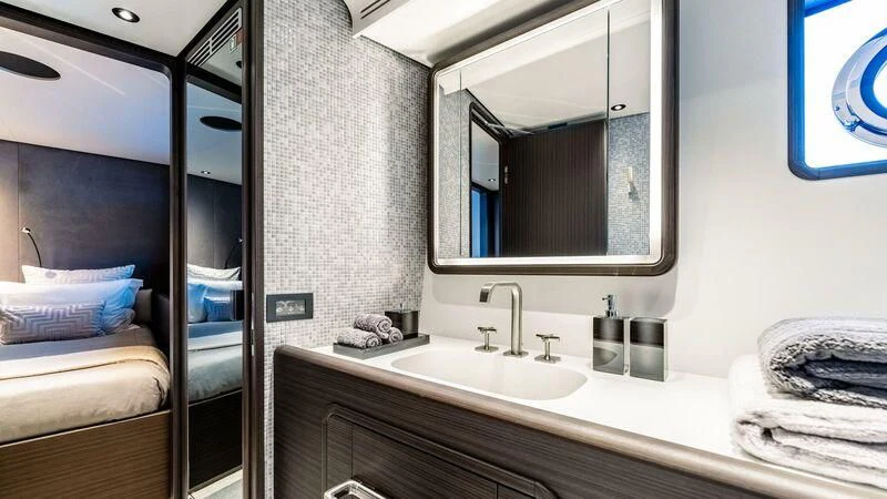 a bathroom with a large mirror aboard AT ONE Yacht for Charter