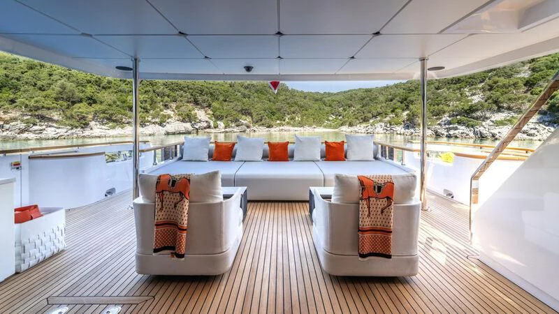 a deck with a couch and chairs aboard AT ONE Yacht for Charter