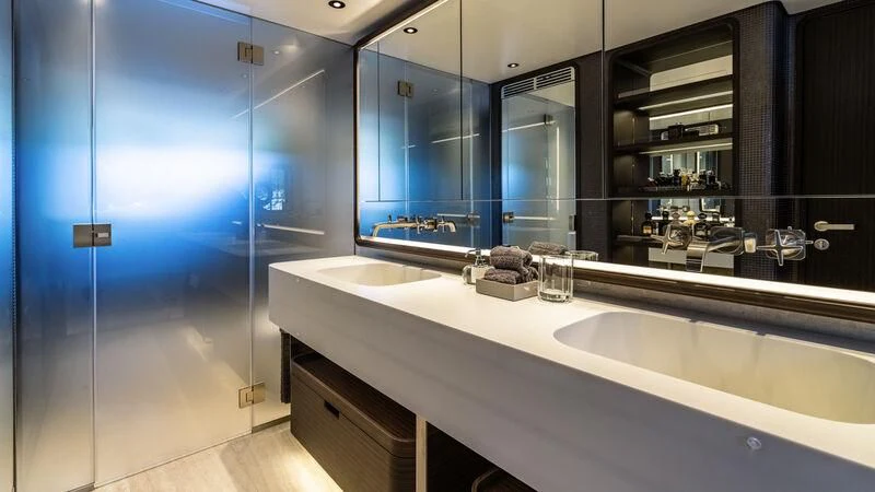 a bathroom with a countertop sink and a mirror aboard AT ONE Yacht for Charter