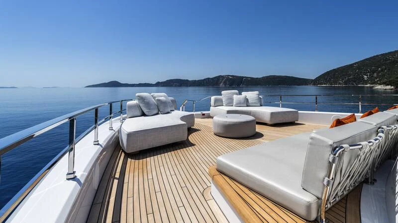 a deck with a view of the ocean and a large body of water aboard AT ONE Yacht for Charter