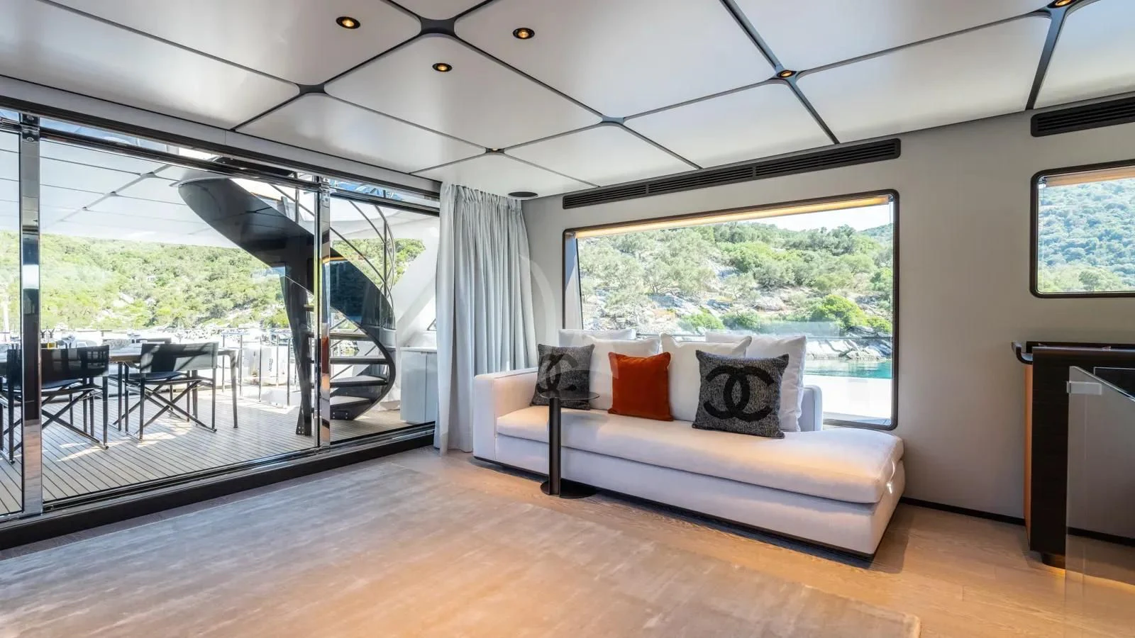 a large living room with a large window aboard AT ONE Yacht for Charter