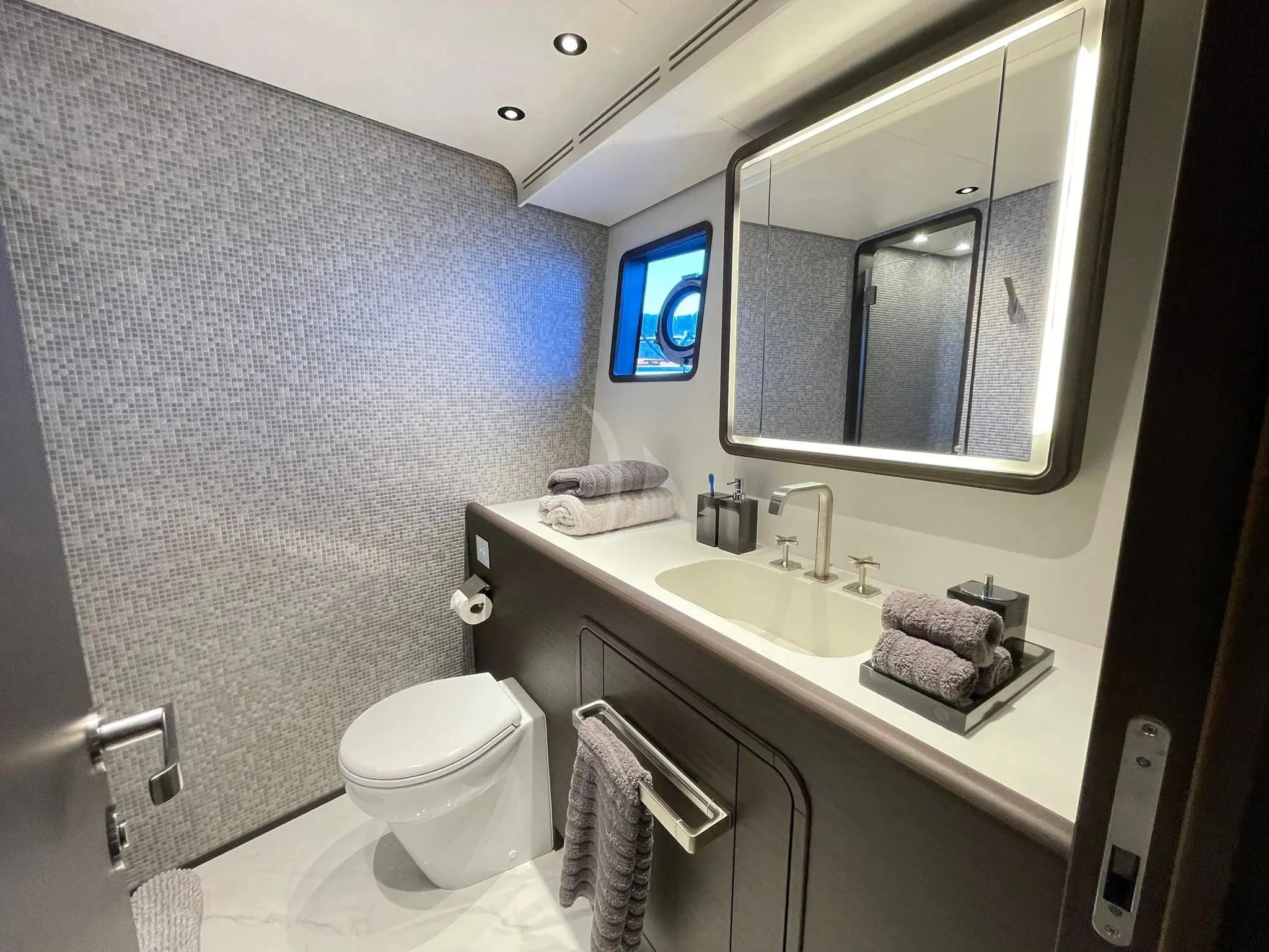 a bathroom with a toilet and a sink aboard AT ONE Yacht for Charter