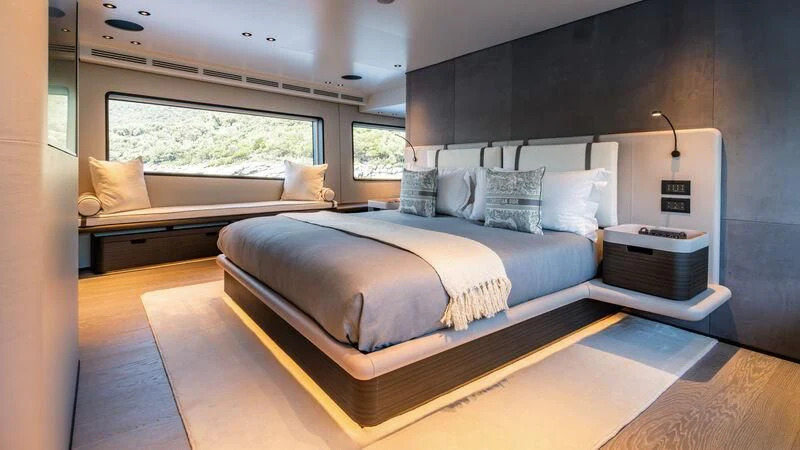 a room with a bed and a window aboard AT ONE Yacht for Charter