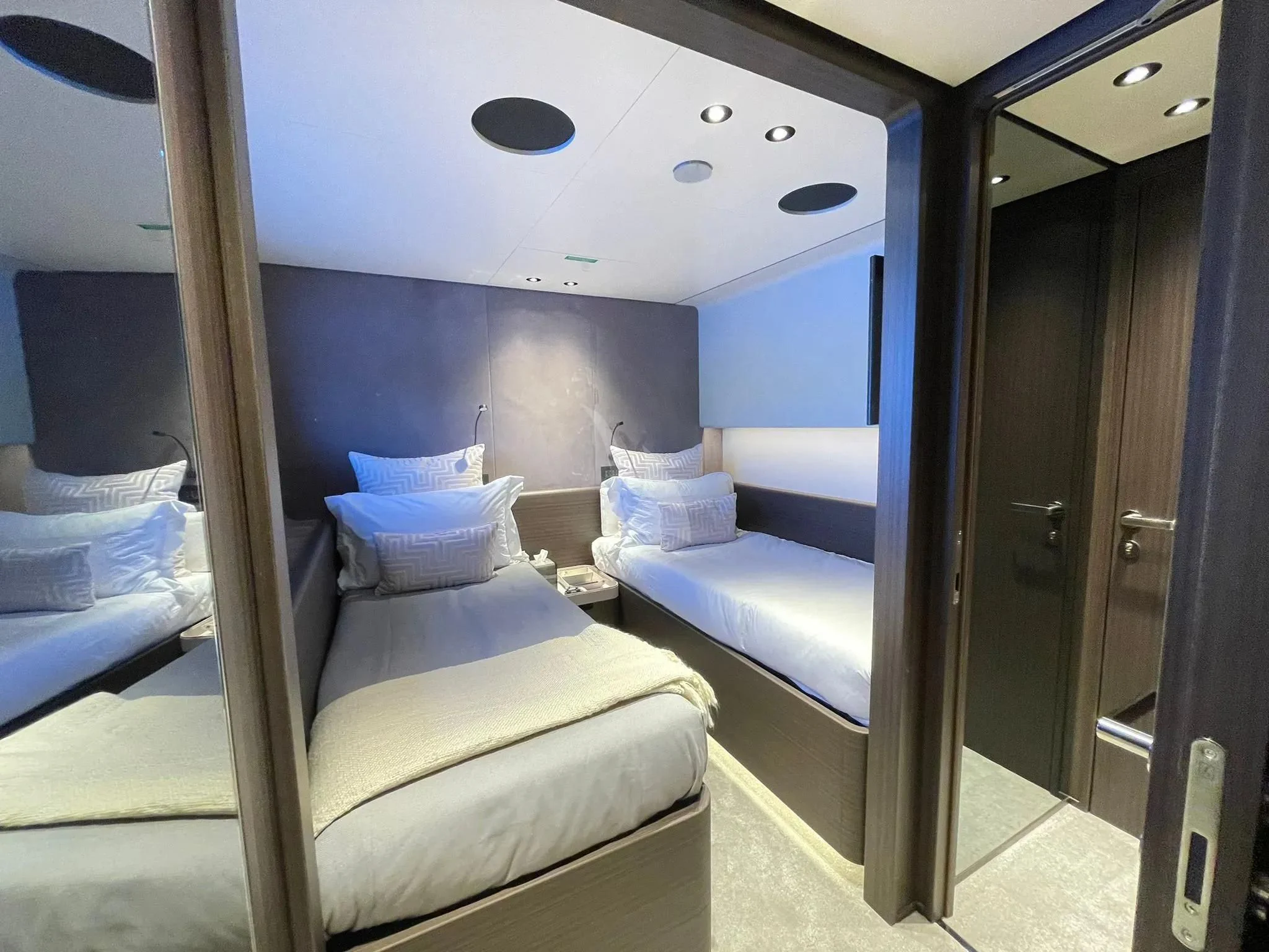 a room with a bed and a mirror aboard AT ONE Yacht for Charter