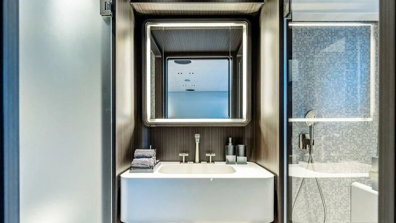 a bathroom with a sink and a mirror aboard AT ONE Yacht for Charter
