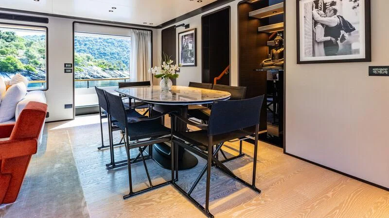 a dining table and chairs in a room aboard AT ONE Yacht for Charter