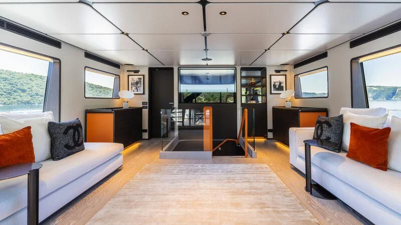 a living room with a large screen aboard AT ONE Yacht for Charter