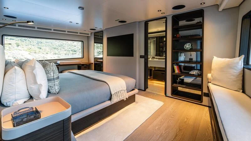a bedroom with a bed and a tv aboard AT ONE Yacht for Charter