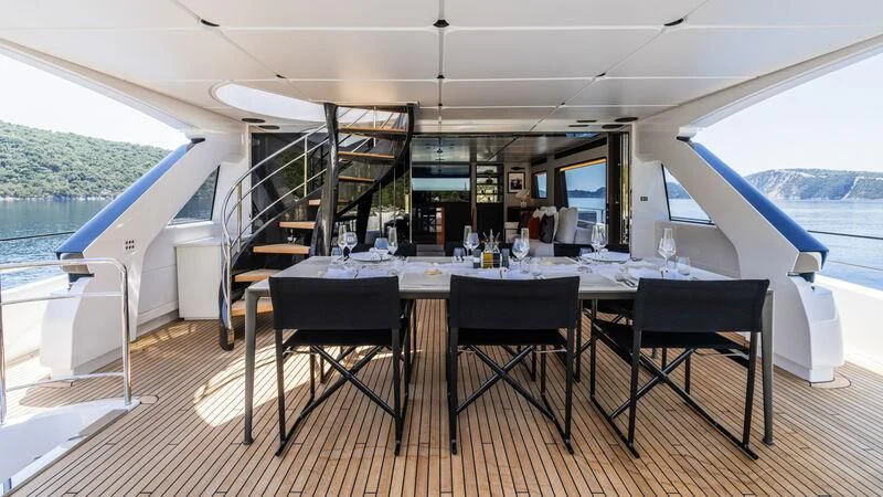 a table with chairs around it aboard AT ONE Yacht for Charter