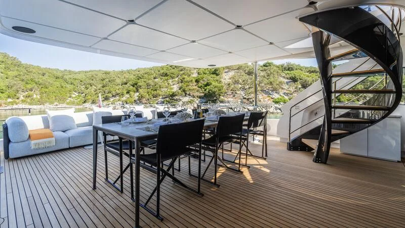 a large patio with a table and chairs aboard AT ONE Yacht for Charter