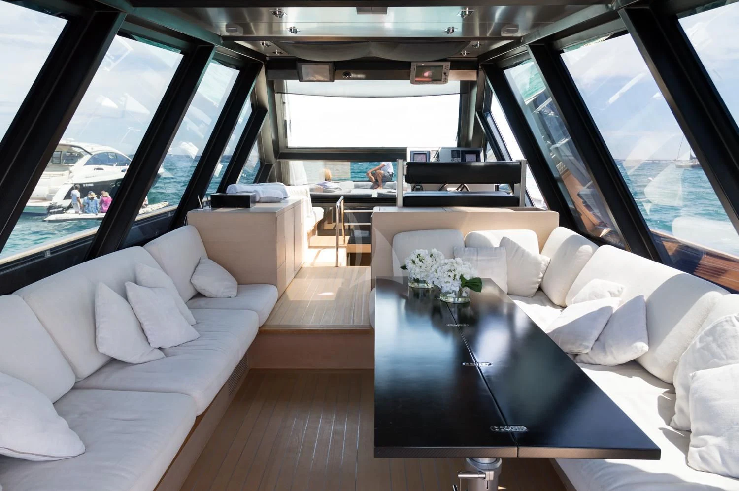 a room with a table and couches aboard ASH Yacht for Sale