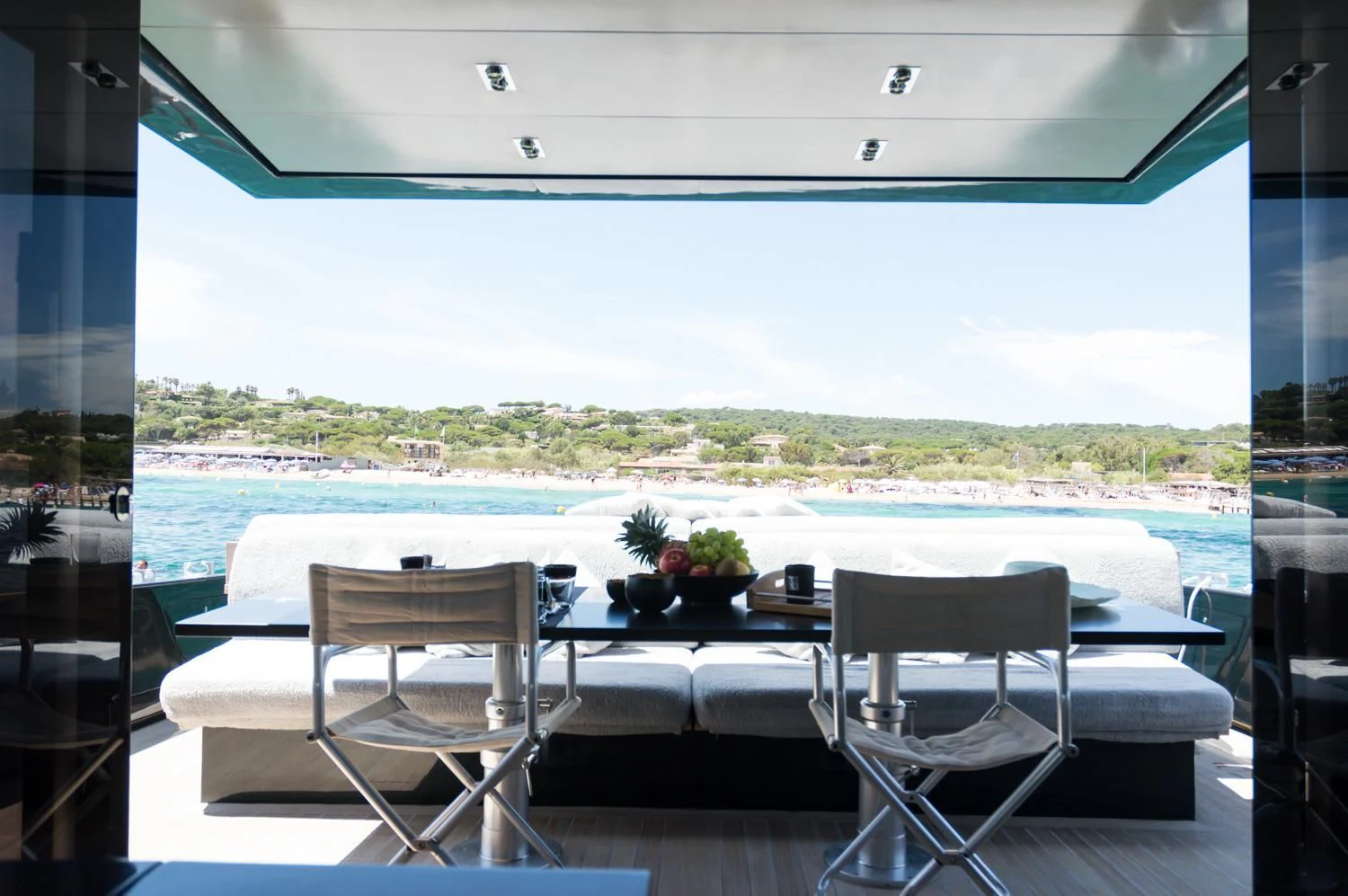 a room with a table chairs and a view of a city aboard ASH Yacht for Sale