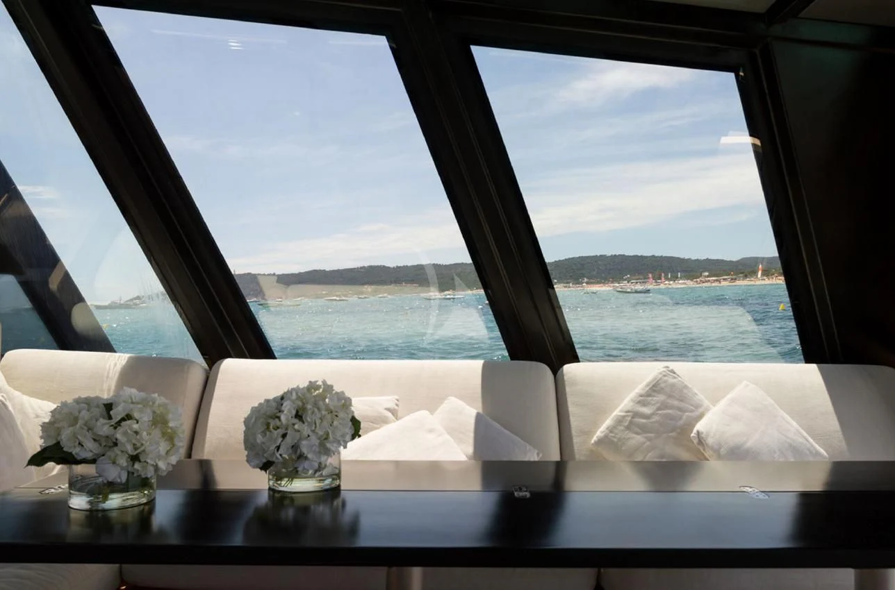 a room with a window and flowers aboard ASH Yacht for Sale