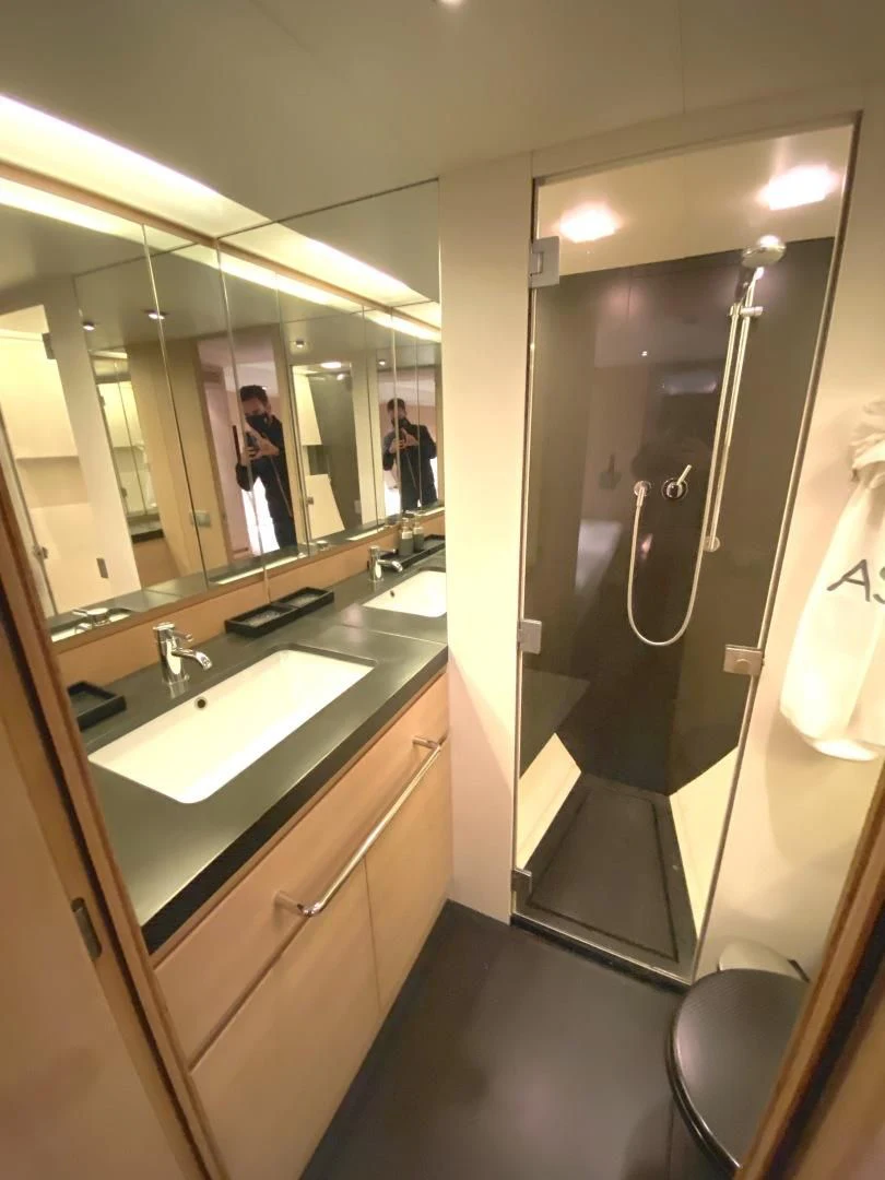 a bathroom with a large mirror aboard ASH Yacht for Sale