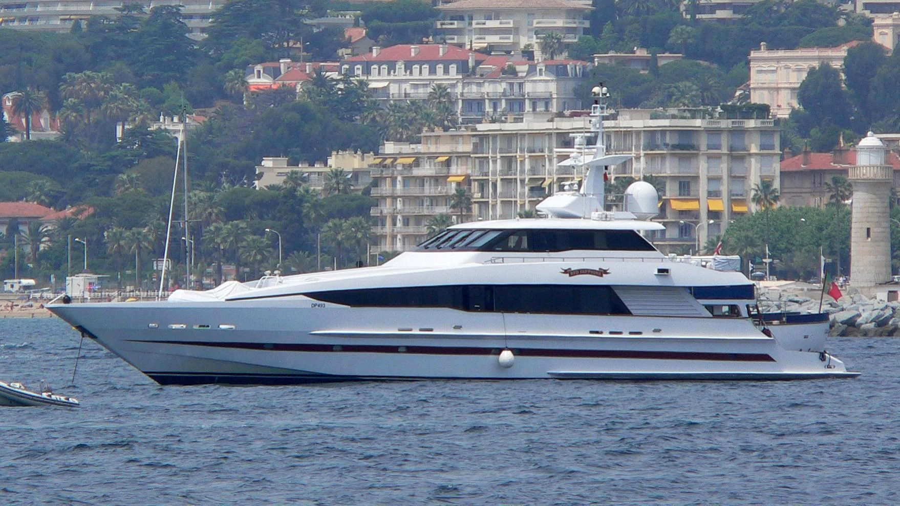 a white yacht in a harbor aboard RED SAPPHIRE I Yacht for Sale