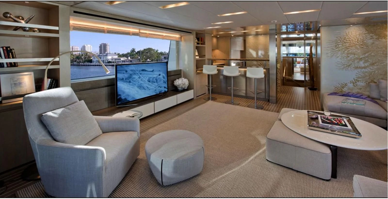 a living room with a large screen aboard INDIGO Yacht for Sale