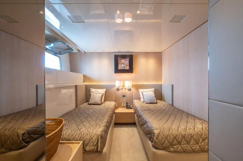 a room with a couple of beds aboard INDIGO Yacht for Sale