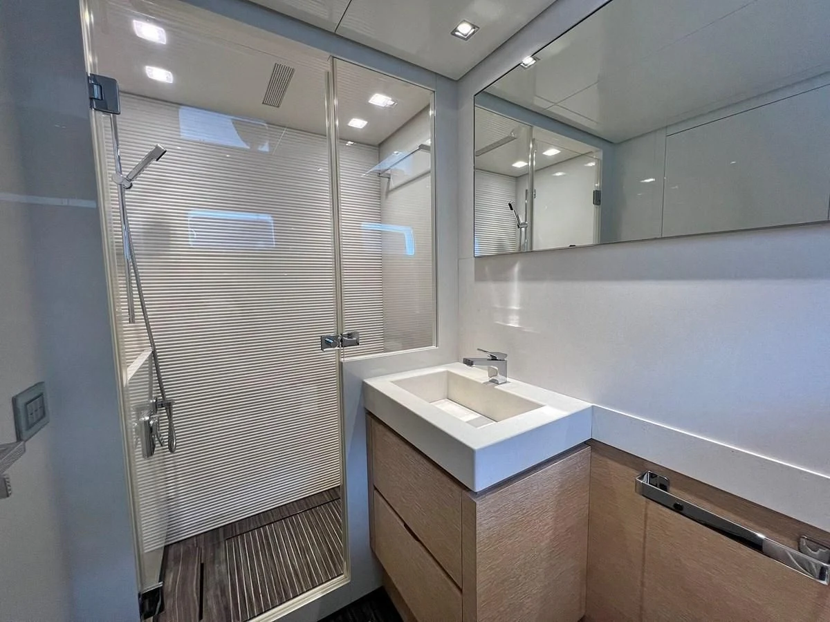 a bathroom with a glass shower aboard INDIGO Yacht for Sale