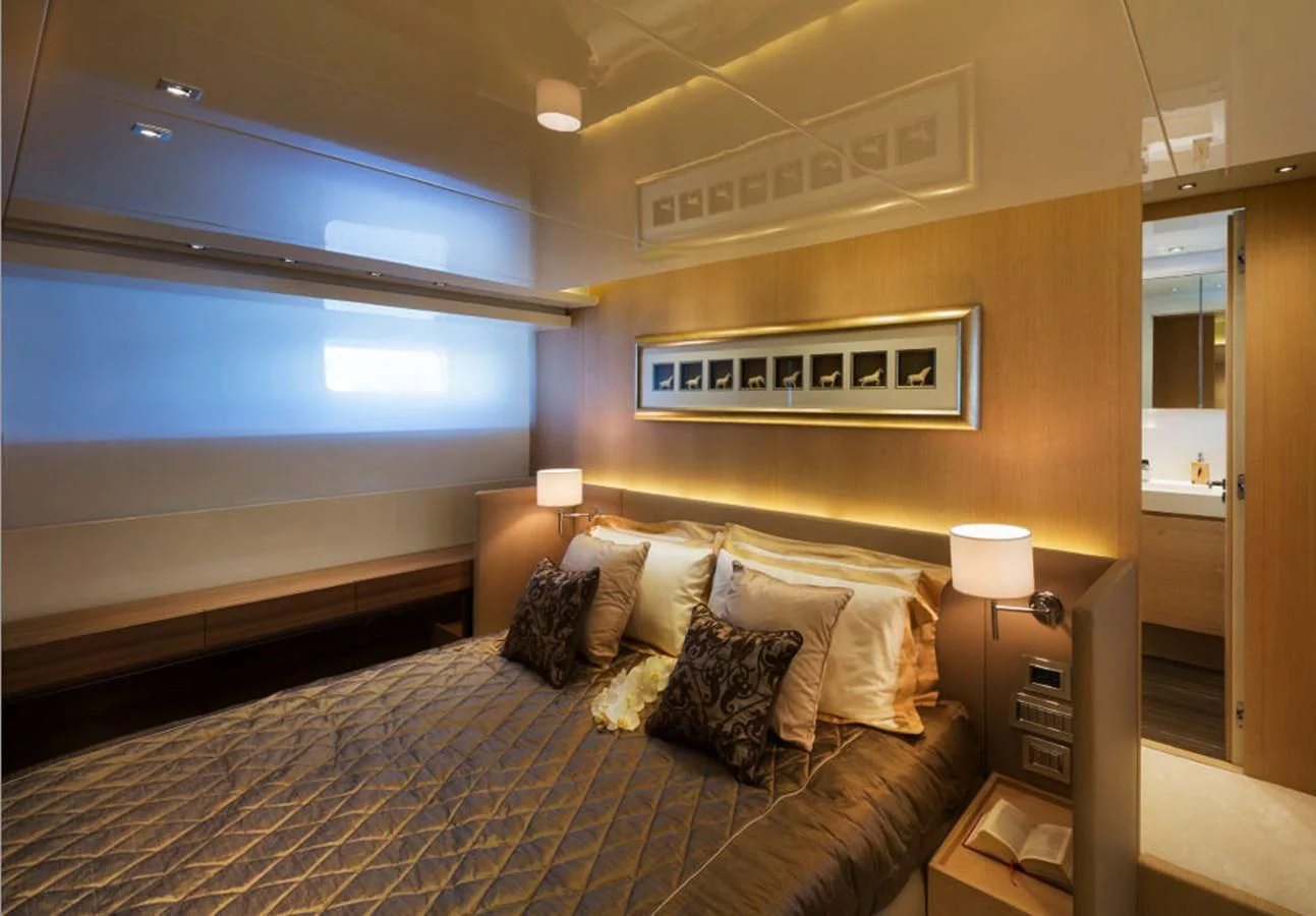 a bedroom with a bed and a desk aboard INDIGO Yacht for Sale