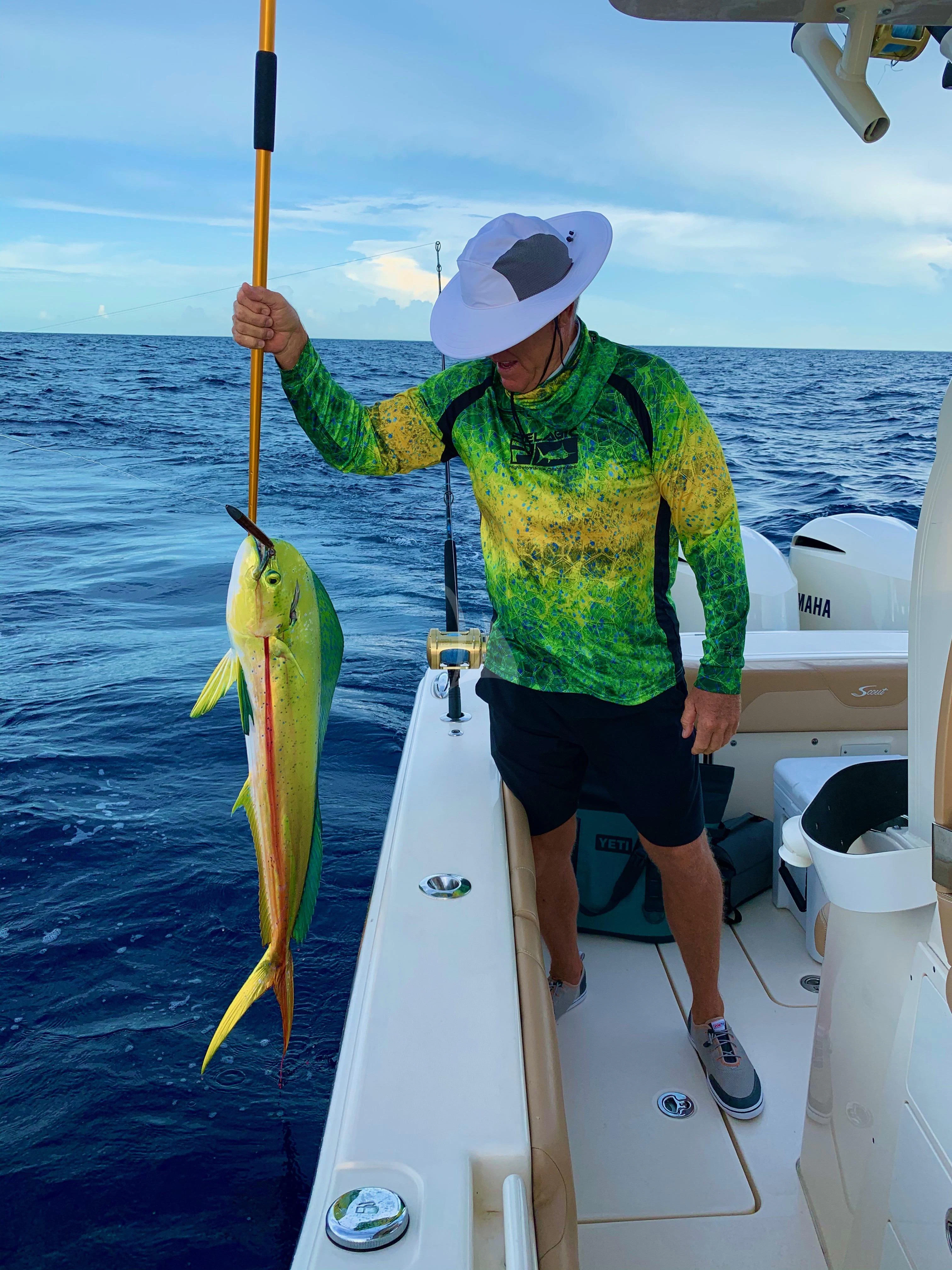 a person holding a fish on a boat aboard INDIGO Yacht for Sale