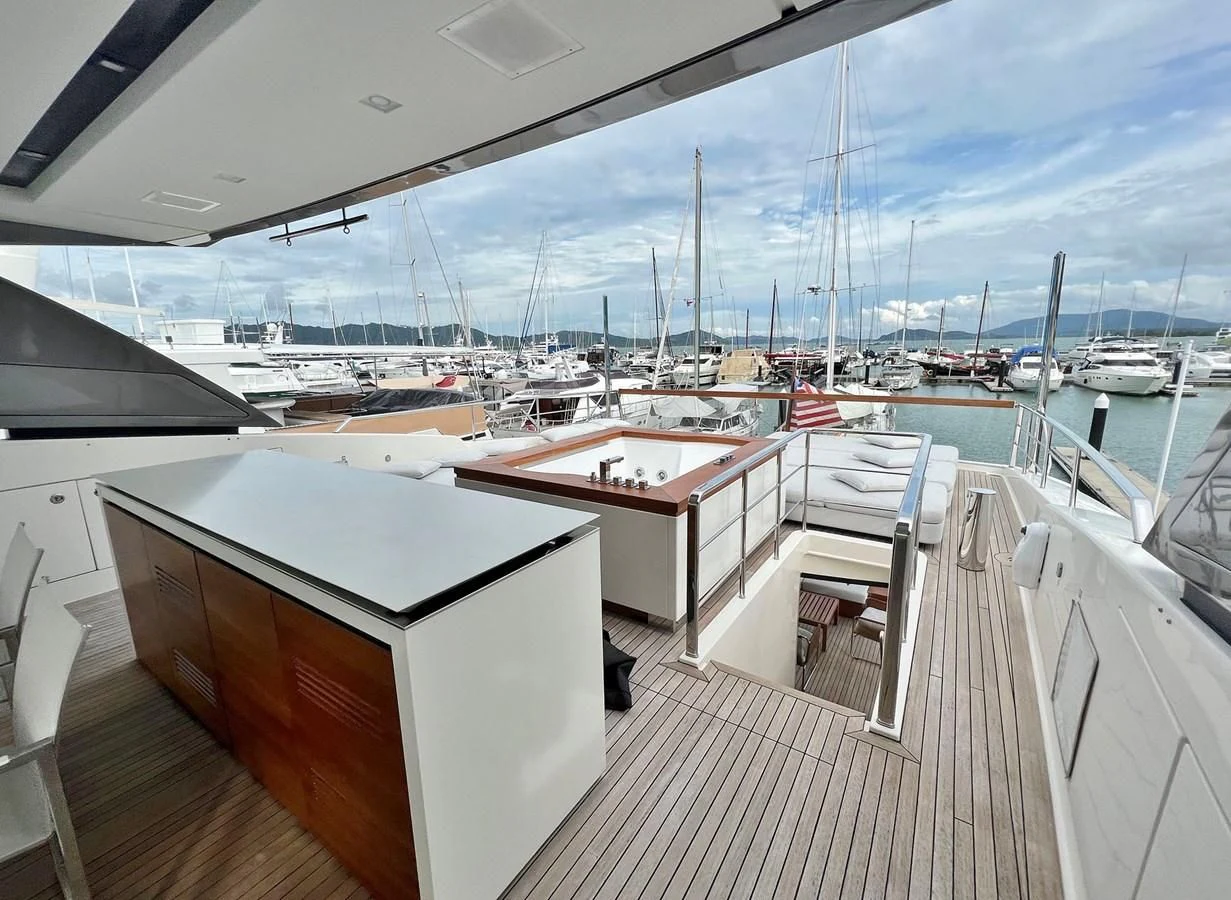 a deck with a view of a marina and boats aboard INDIGO Yacht for Sale