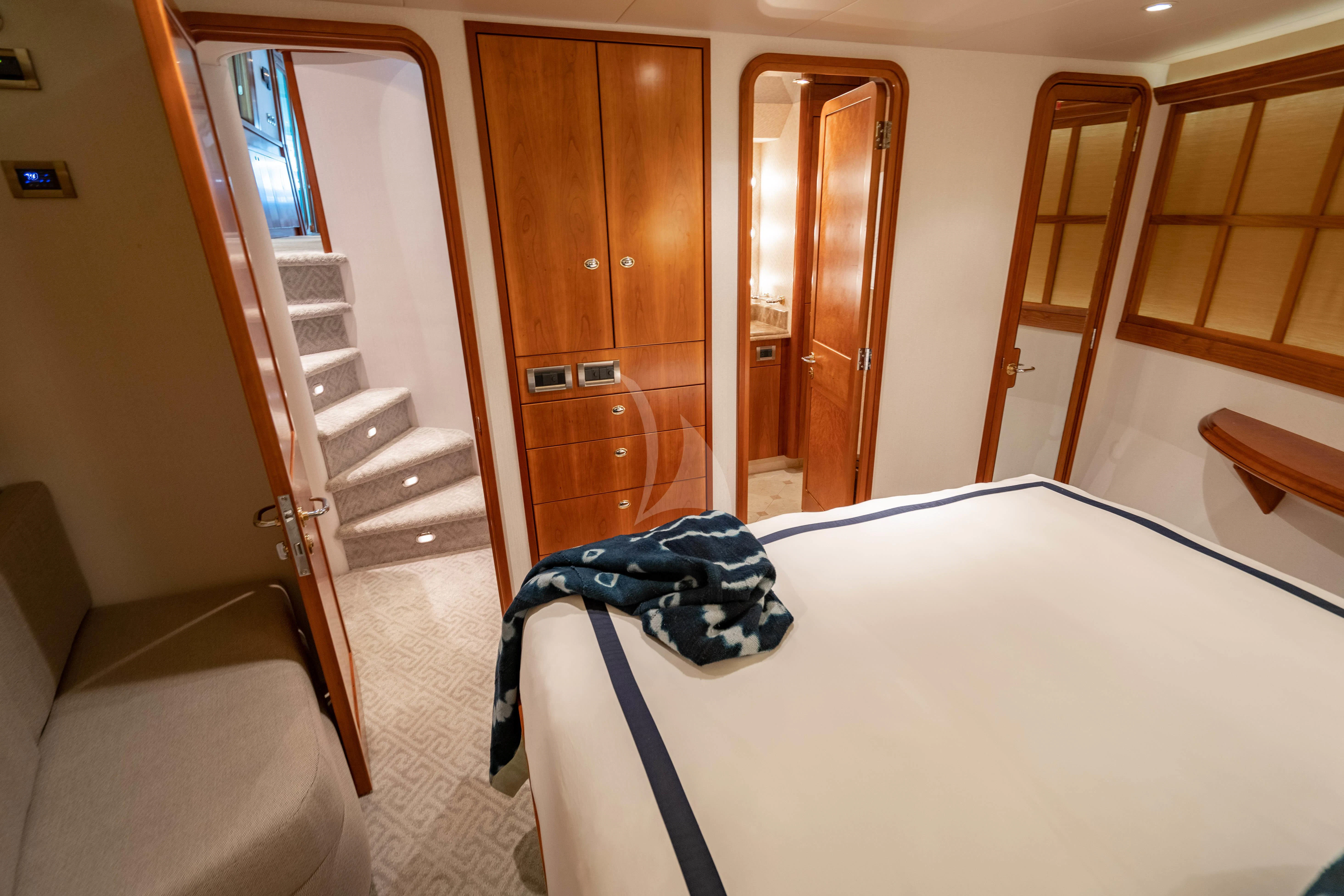 a room with a bed and a door aboard INDIGO Yacht for Sale
