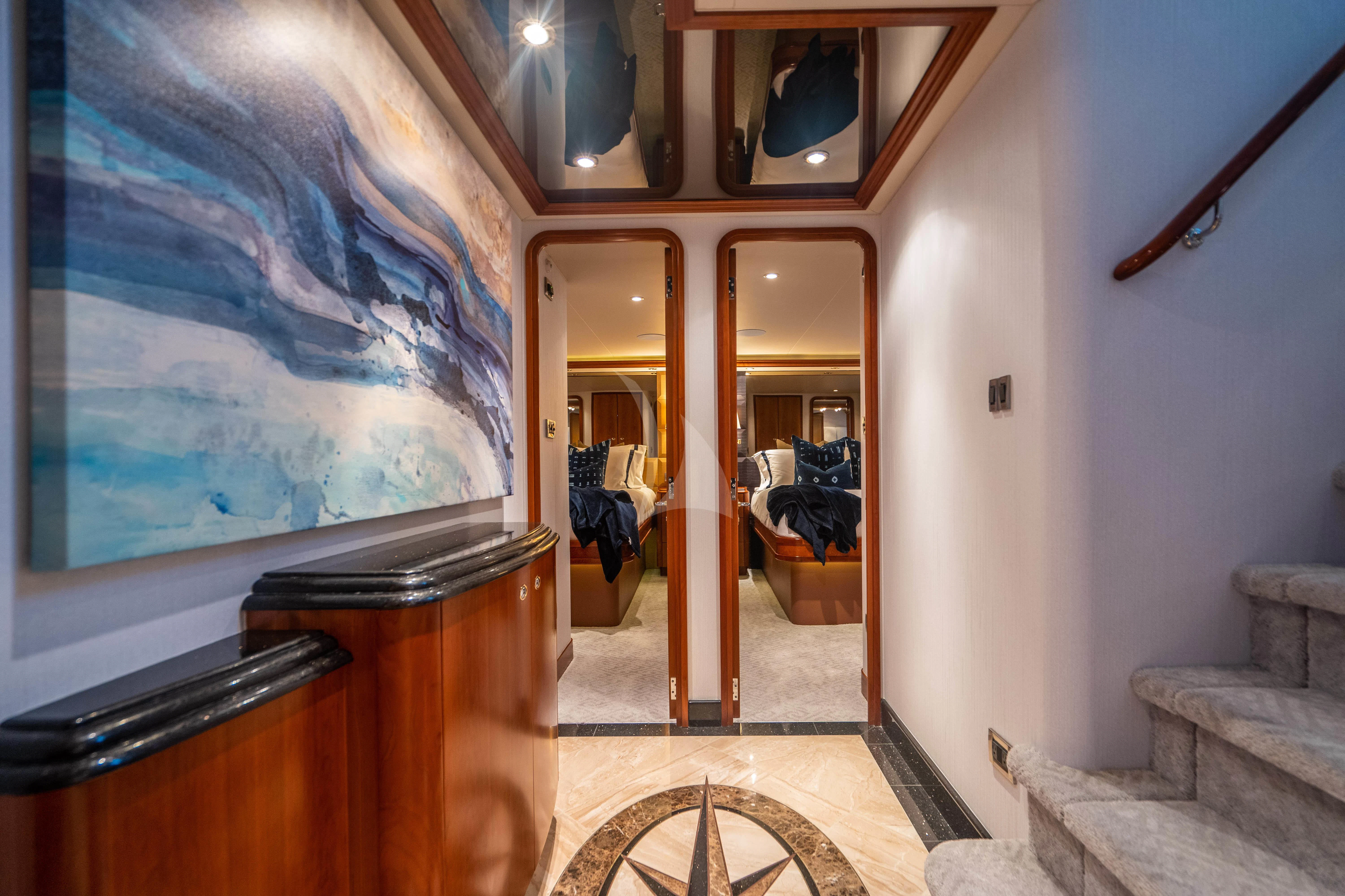 a room with a painting on the wall aboard INDIGO Yacht for Sale