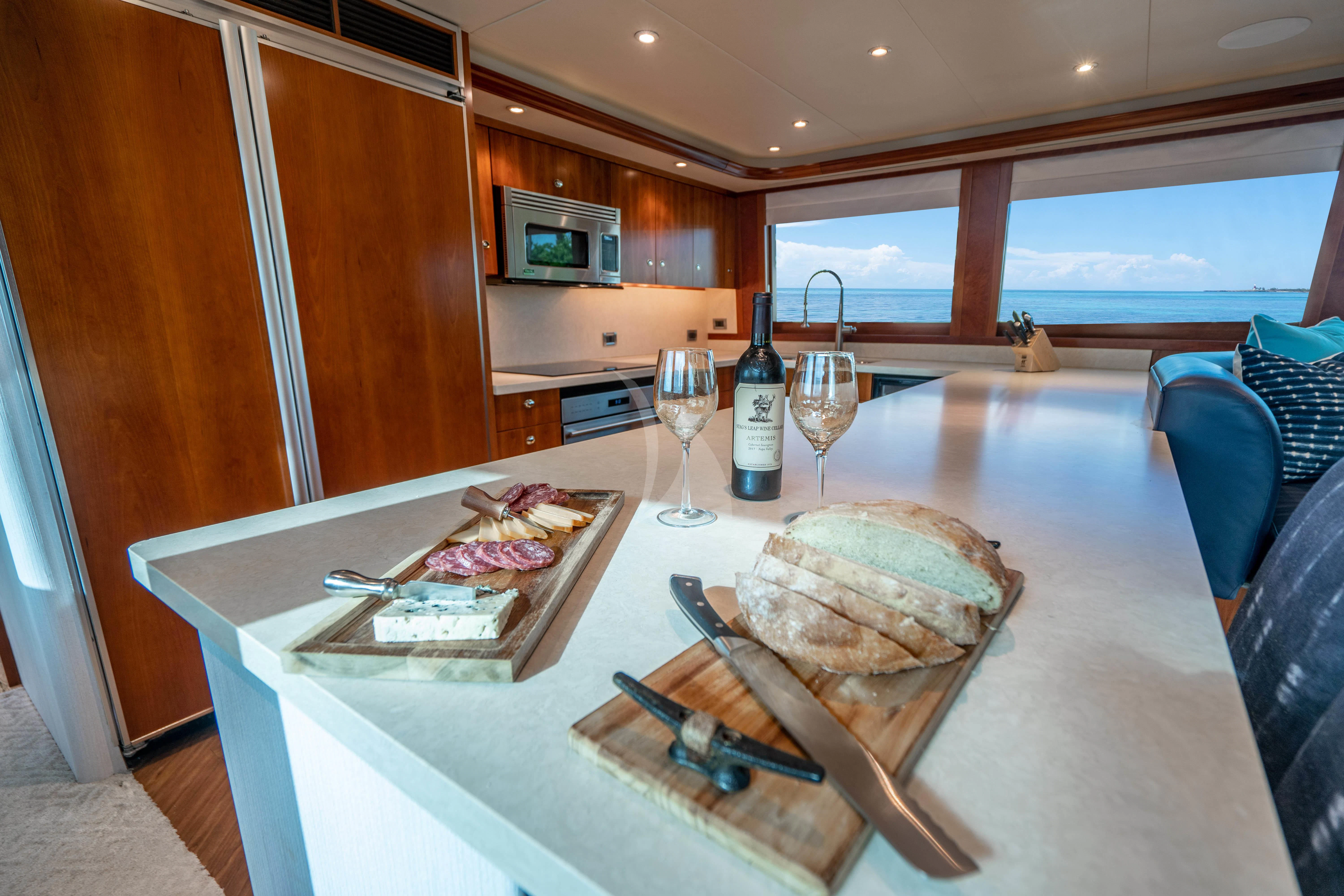 a table with food and wine aboard INDIGO Yacht for Sale