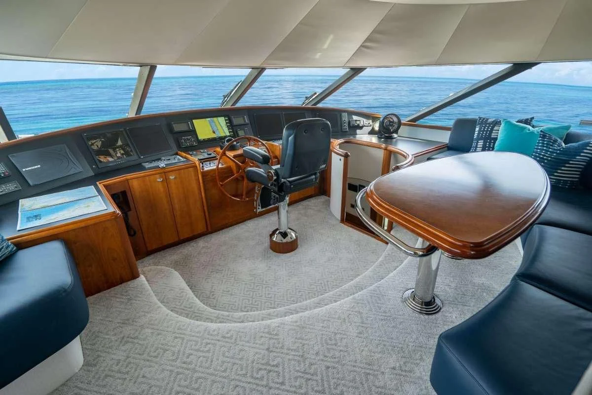 a room with a desk and chairs aboard INDIGO Yacht for Sale