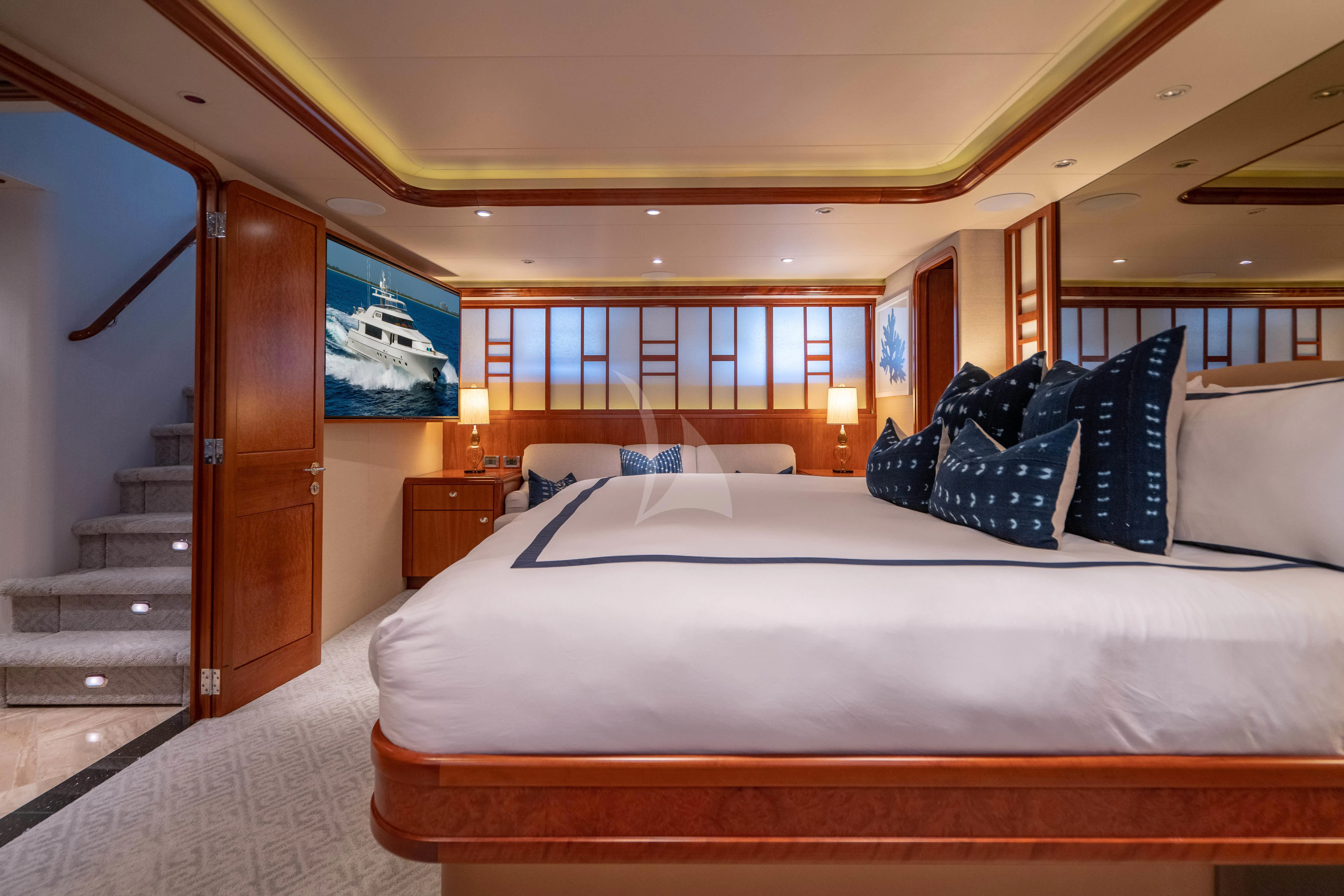 a bed with white sheets and pillows aboard INDIGO Yacht for Sale