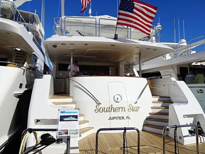 a large military ship with a flag on the deck aboard INDIGO Yacht for Sale
