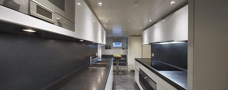 a kitchen with a large island aboard INDIGO Yacht for Sale