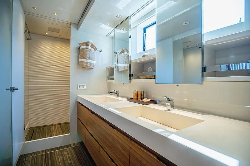 a bathroom with a countertop sink and cabinets aboard INDIGO Yacht for Sale
