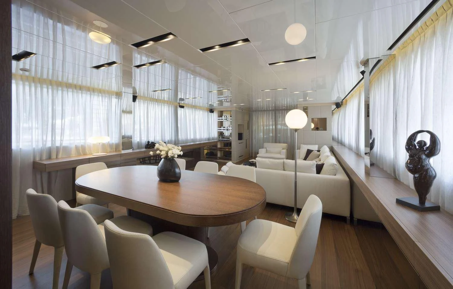 a living room with a table and chairs aboard INDIGO Yacht for Sale