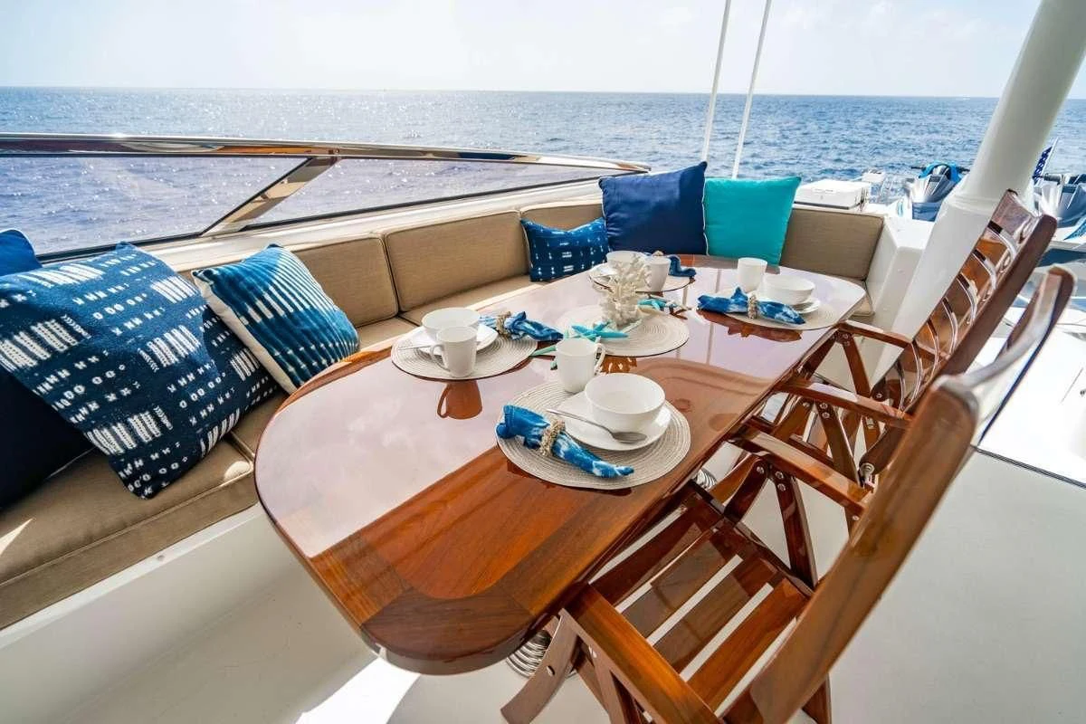 a table with chairs and a table on it aboard INDIGO Yacht for Sale