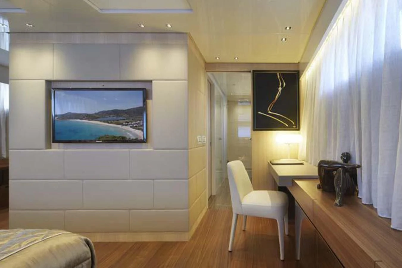 a room with a tv and a chair aboard INDIGO Yacht for Sale
