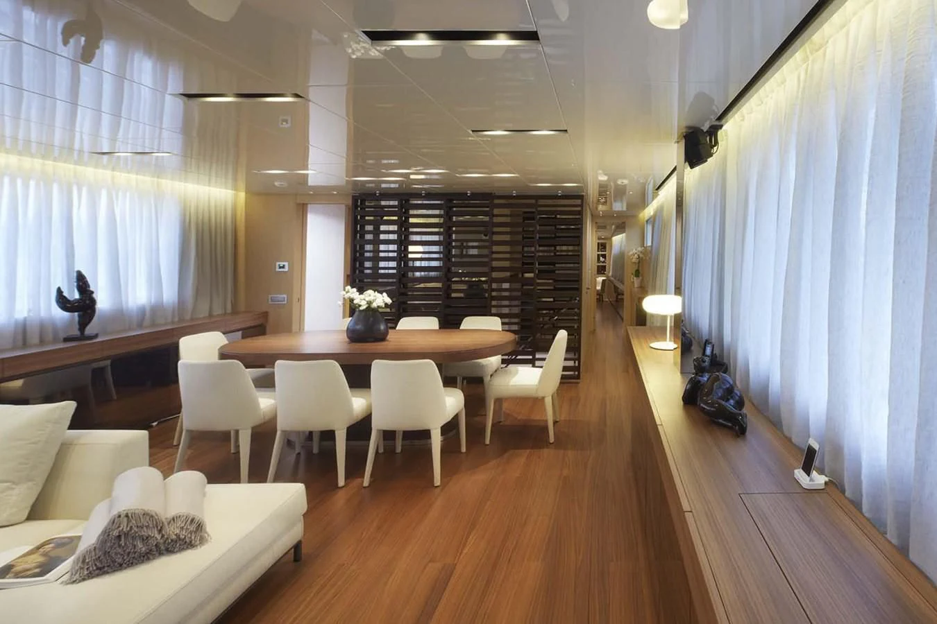 a room with a table chairs and a couch aboard INDIGO Yacht for Sale