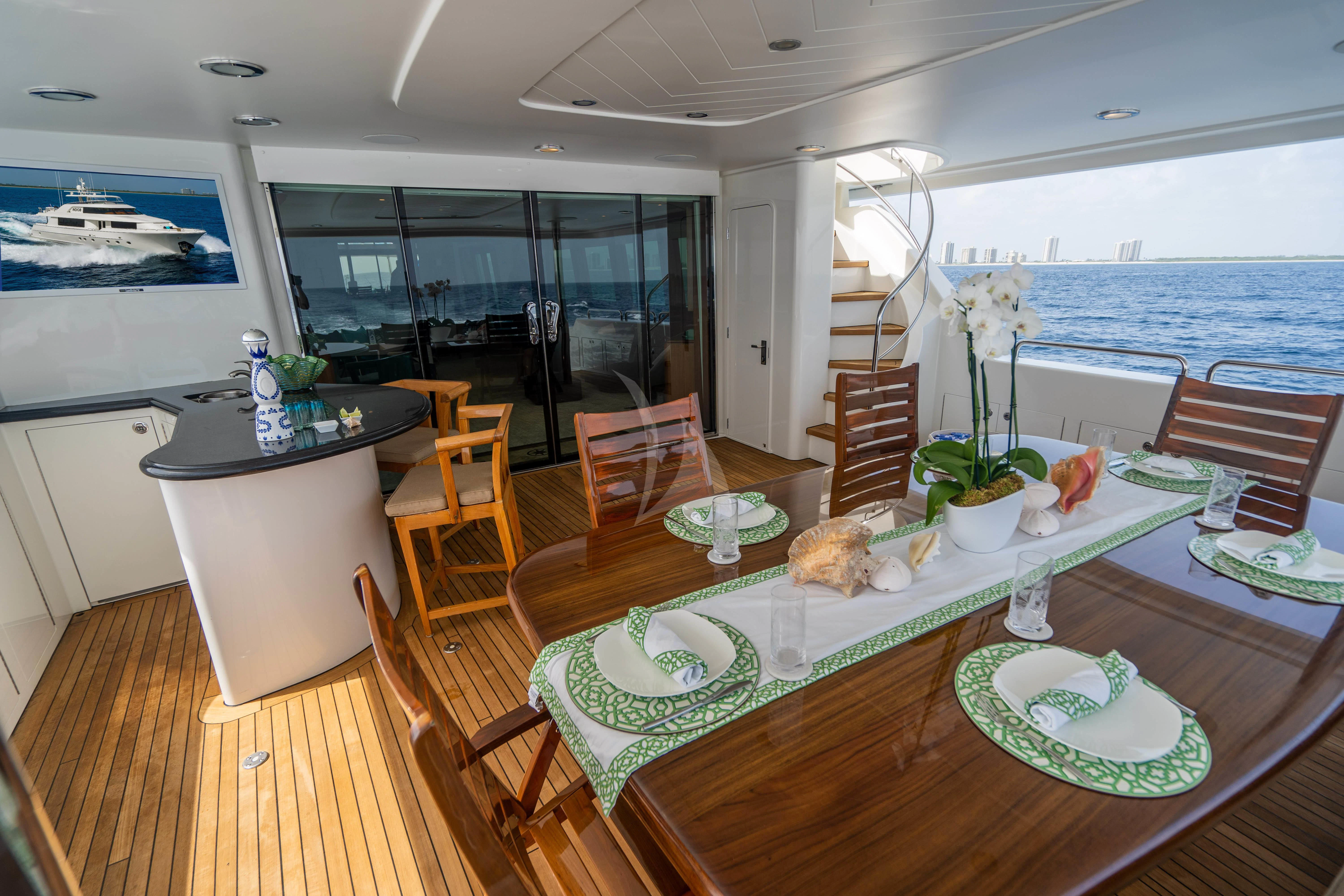 a dining room with a table and chairs aboard INDIGO Yacht for Sale