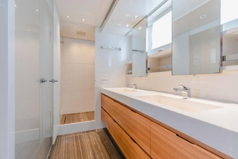 a bathroom with a countertop sink and a mirror aboard INDIGO Yacht for Sale