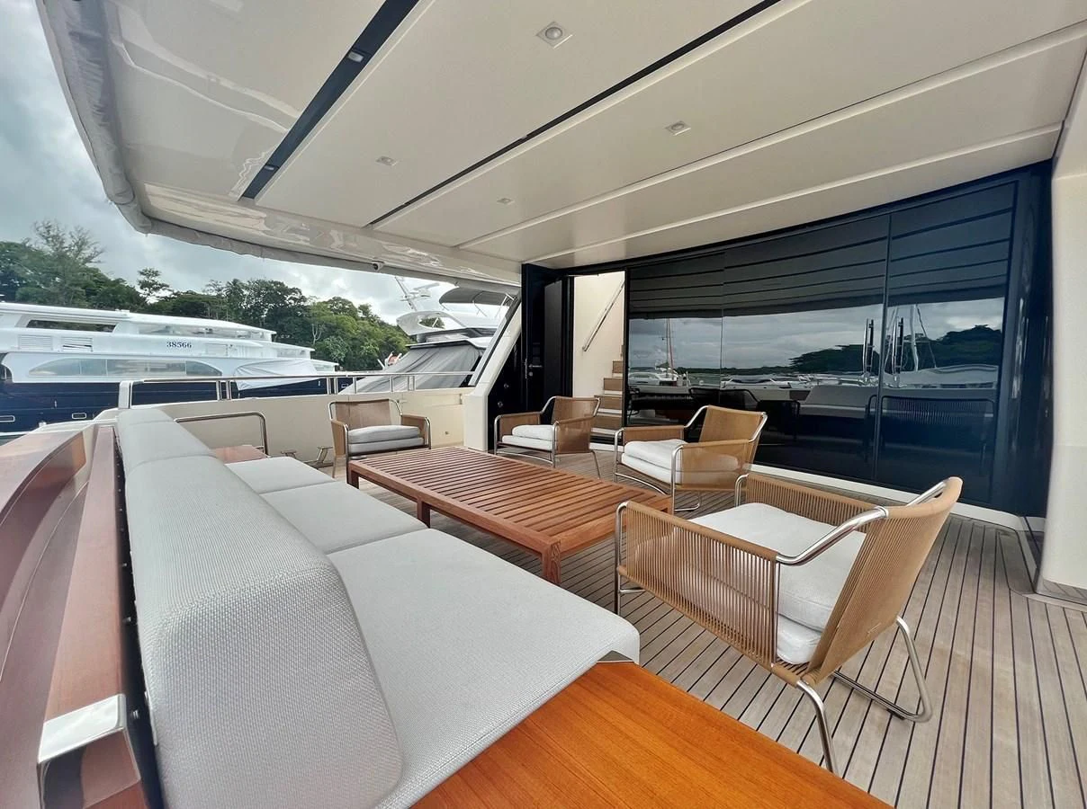 a room with a couch and a table and chairs aboard INDIGO Yacht for Sale