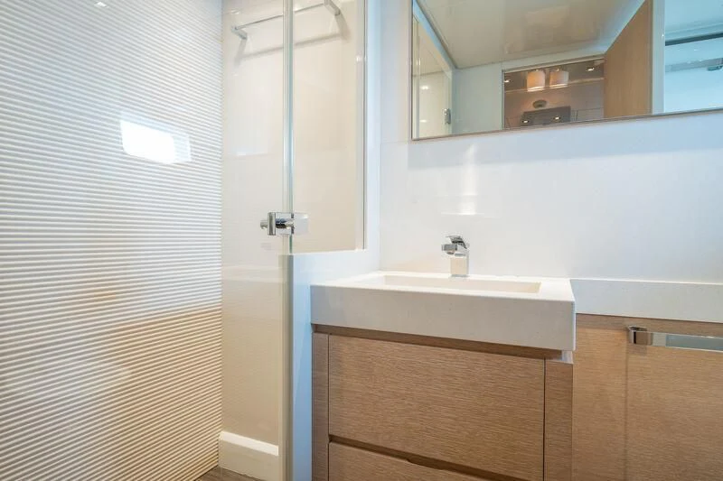 a bathroom with a sink and a mirror aboard INDIGO Yacht for Sale