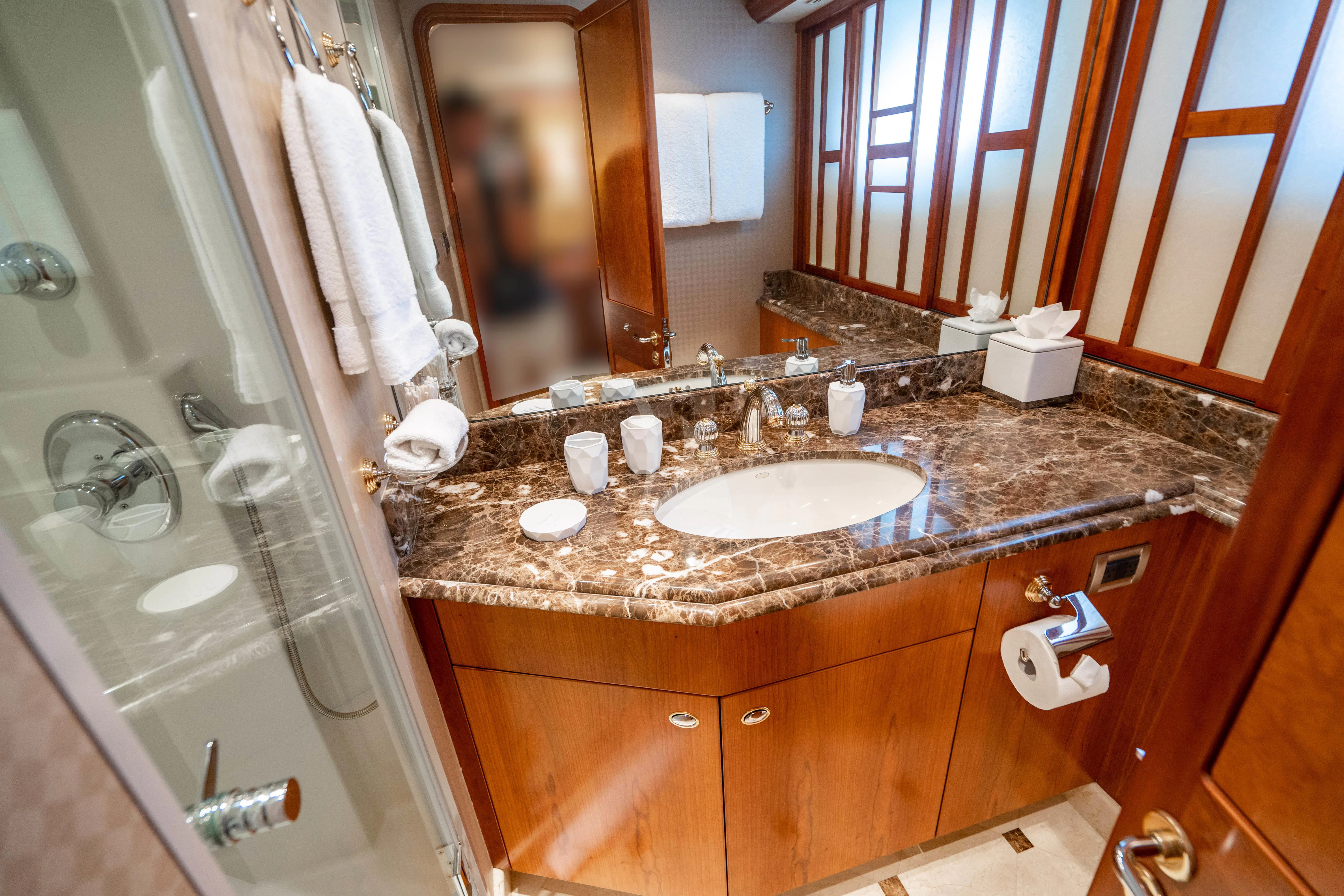 a bathroom with a sink and a shower aboard INDIGO Yacht for Sale