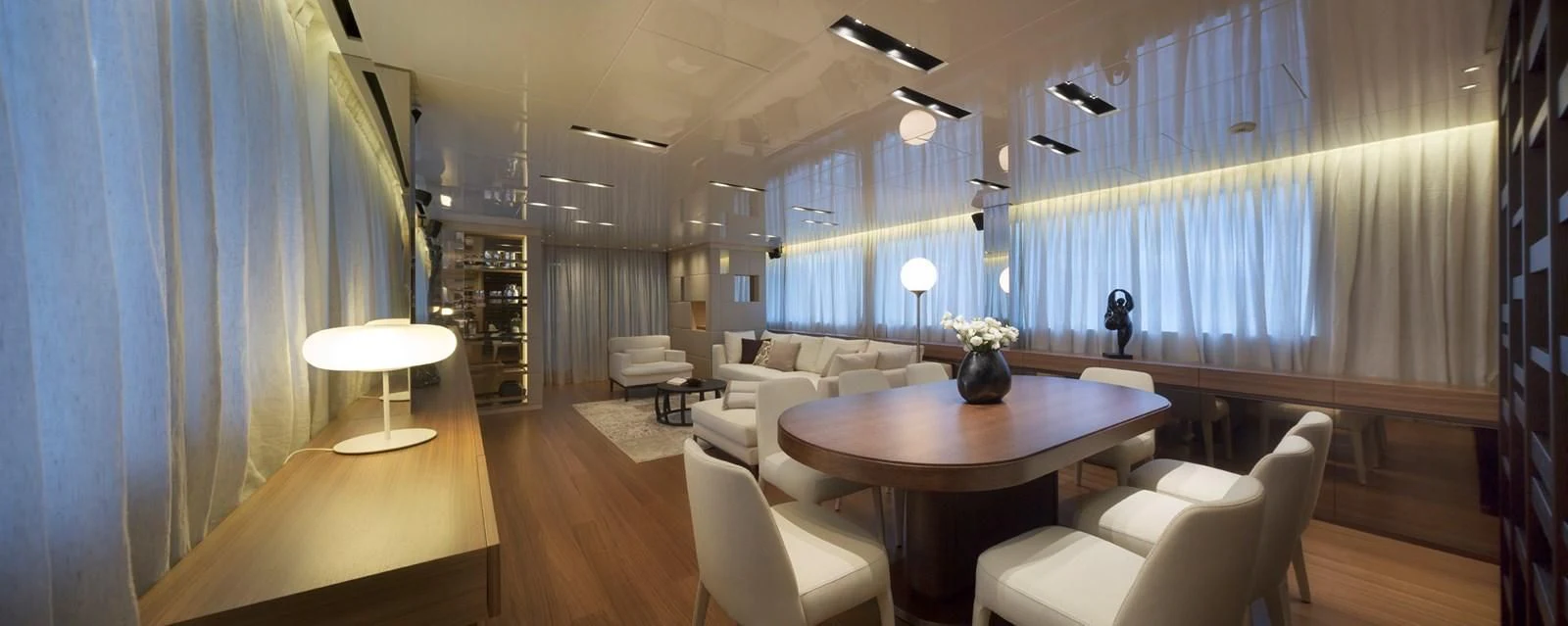 a room with a table chairs and a couch aboard INDIGO Yacht for Sale